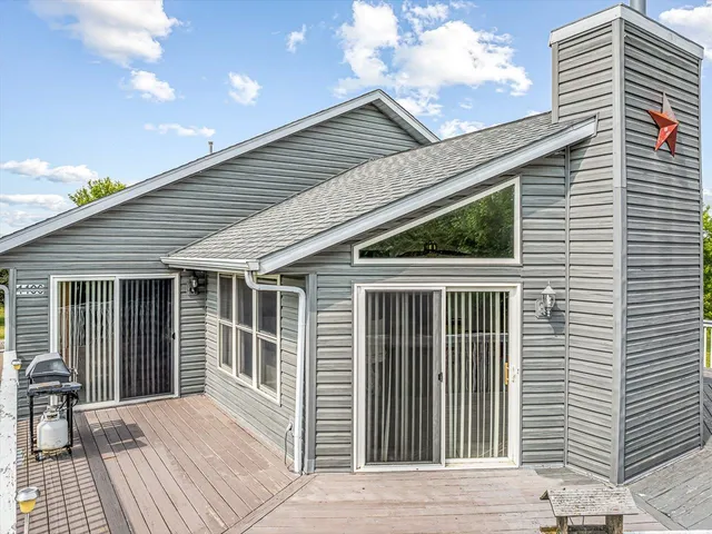 a aerial view of a house with a yard balcony and outdoor seating