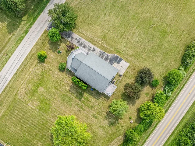 an aerial view of residential houses with outdoor space and ocean view