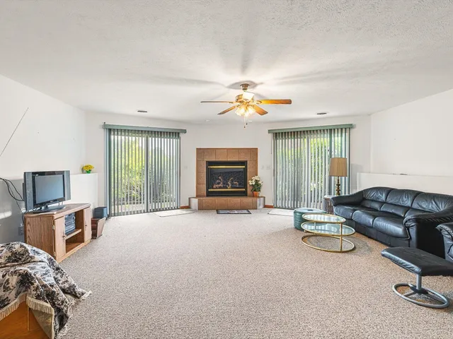a view of livingroom with furniture fireplace and window