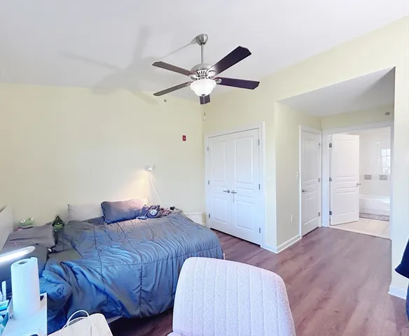 a bedroom with a bed and a ceiling fan