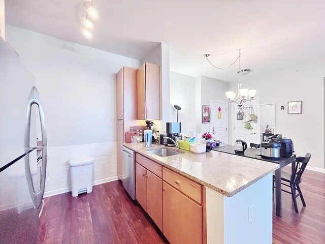 a kitchen with a sink cabinets and wooden floor