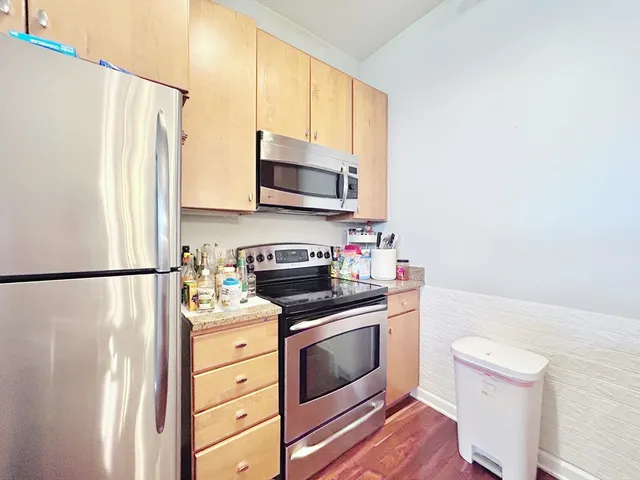 a kitchen with a refrigerator stove and microwave