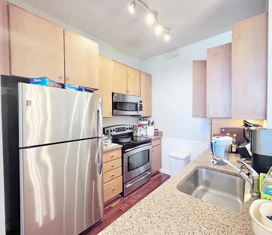 a kitchen with a refrigerator sink and stove