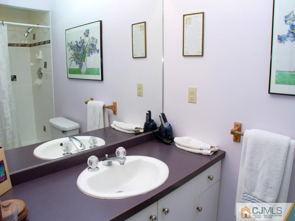 8 Maher Road Somerset, NJ 08873 - Photo 15 of 25 a bathroom with a sink double vanity and a mirror