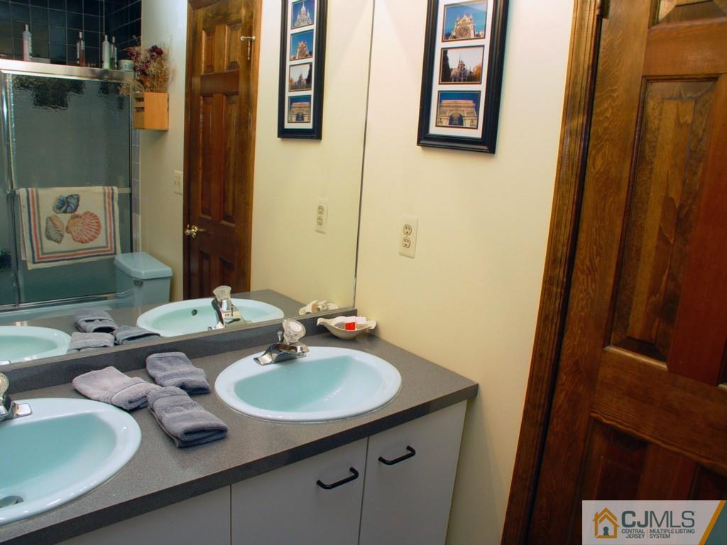 8 Maher Road Somerset, NJ 08873 - Photo 17 of 25 a bathroom with a granite countertop sink and a mirror