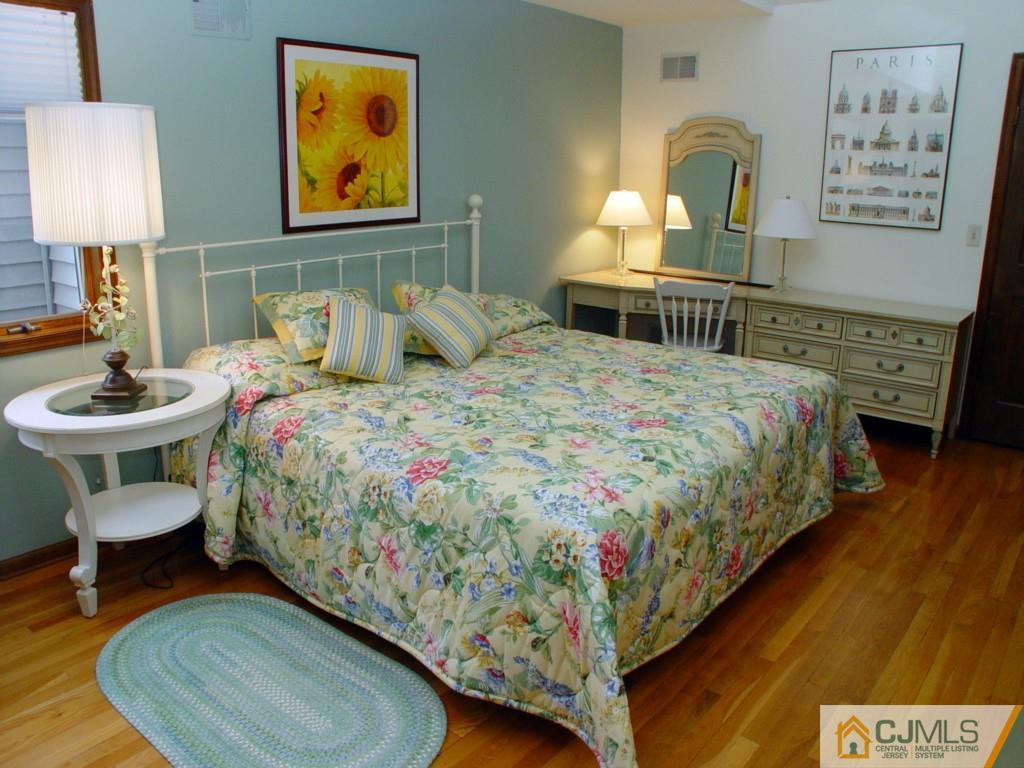 8 Maher Road Somerset, NJ 08873 - Photo 18 of 25 a bedroom with a bed and wooden floor