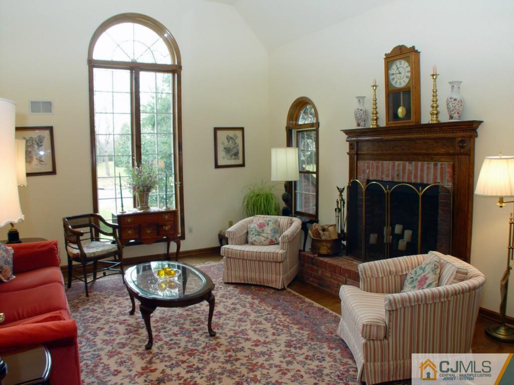 8 Maher Road Somerset, NJ 08873 - Photo 3 of 25 a living room with furniture a fireplace and a large window