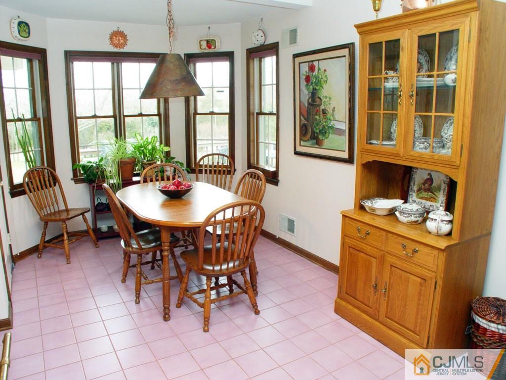 8 Maher Road Somerset, NJ 08873 - Photo 9 of 25 a dining room with furniture a rug and a floor to ceiling window