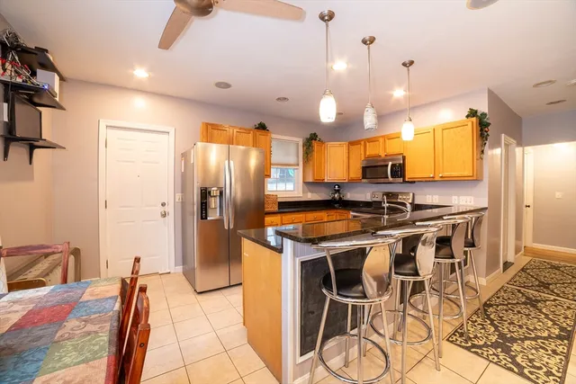 a kitchen with stainless steel appliances granite countertop a stove and a refrigerator