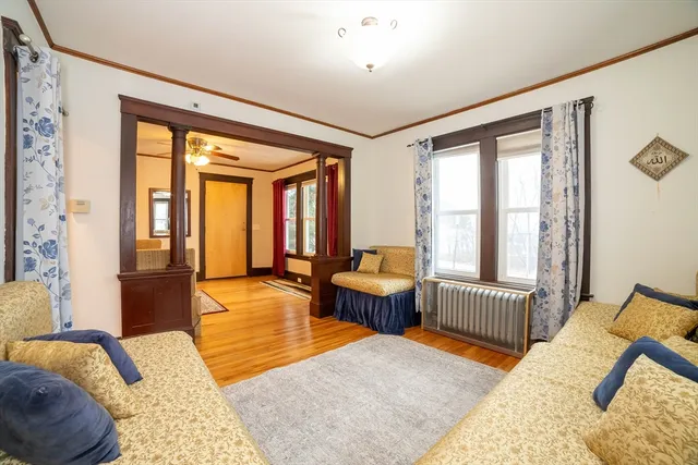 a bedroom with furniture and a large window