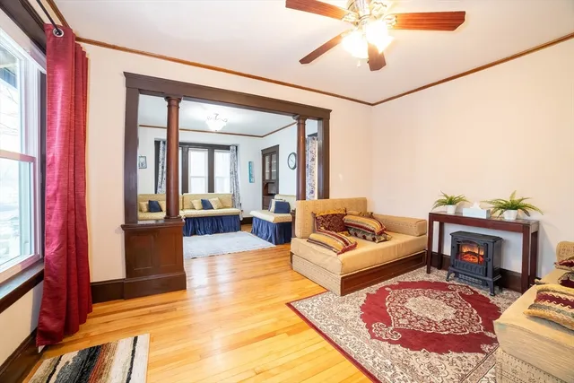 a living room with furniture a rug and a chandelier