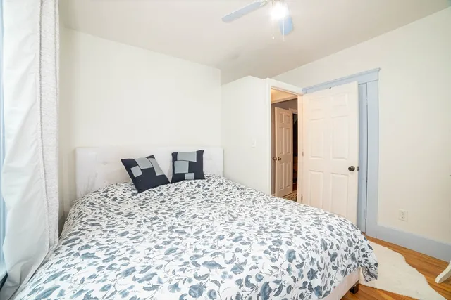 a large bed sitting in a bedroom next to a bathroom