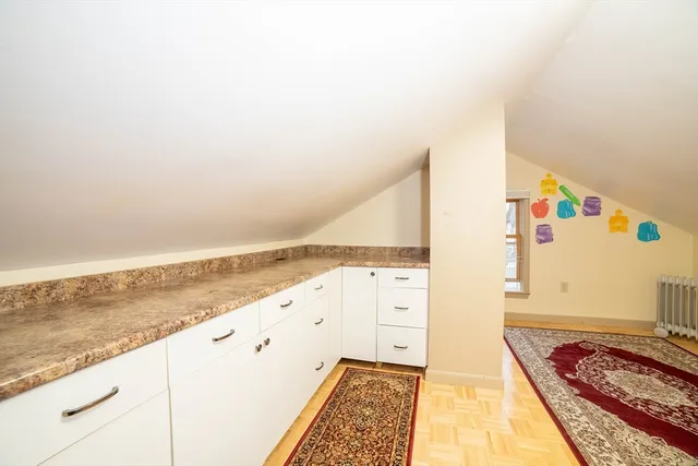 a view of a bedroom with wooden floor