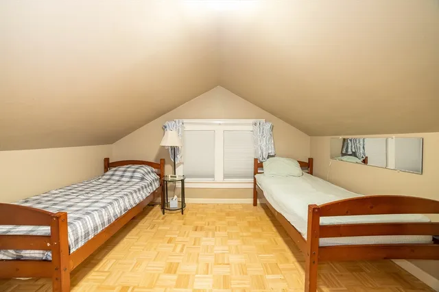 a spacious bedroom with a bed and a window