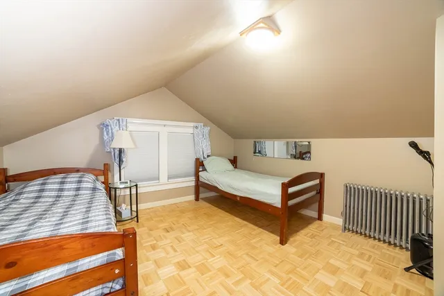 a bedroom with a bed and window