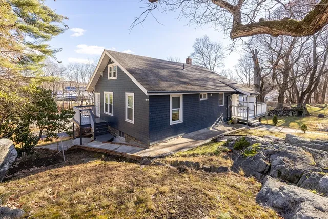 a view of a house with a yard covered in snow