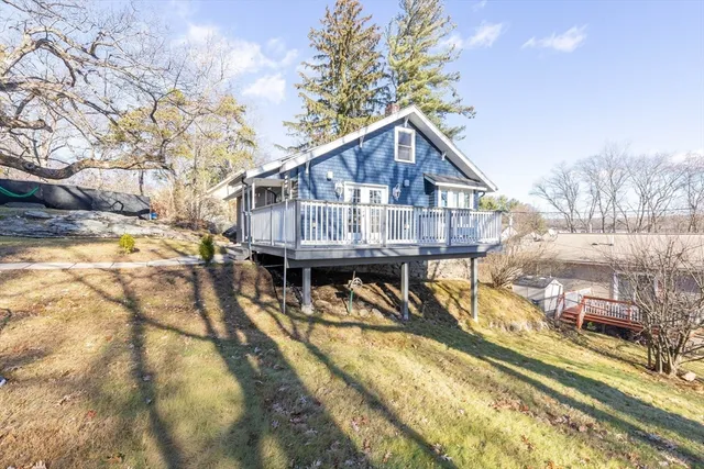 a view of a house with pool and sitting area