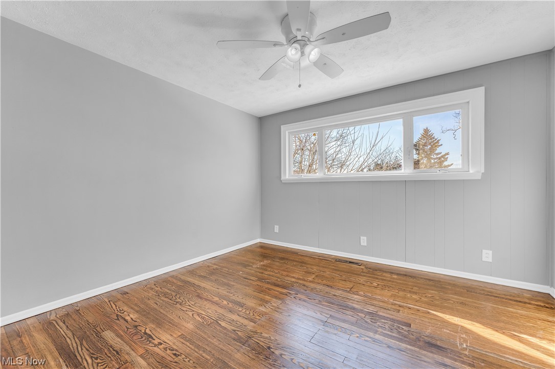 3557 Ludgate Road Cleveland, OH 44120 - Photo 18 of 32 Unfurnished room with dark wood-type flooring and ceiling fan