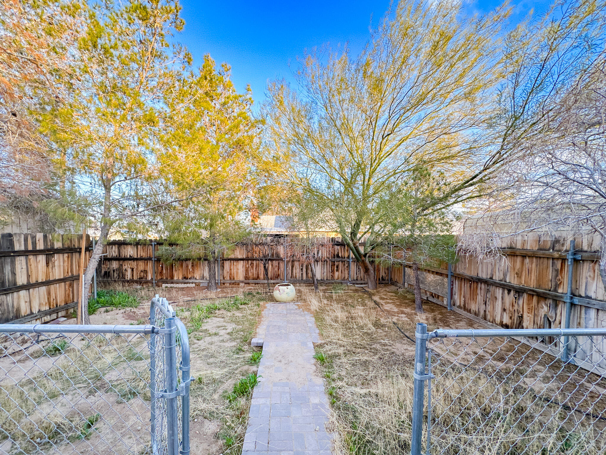 1228 West St George Avenue Ridgecrest, CA 93555 - Photo 15 of 30 a view of a yard with wooden fence