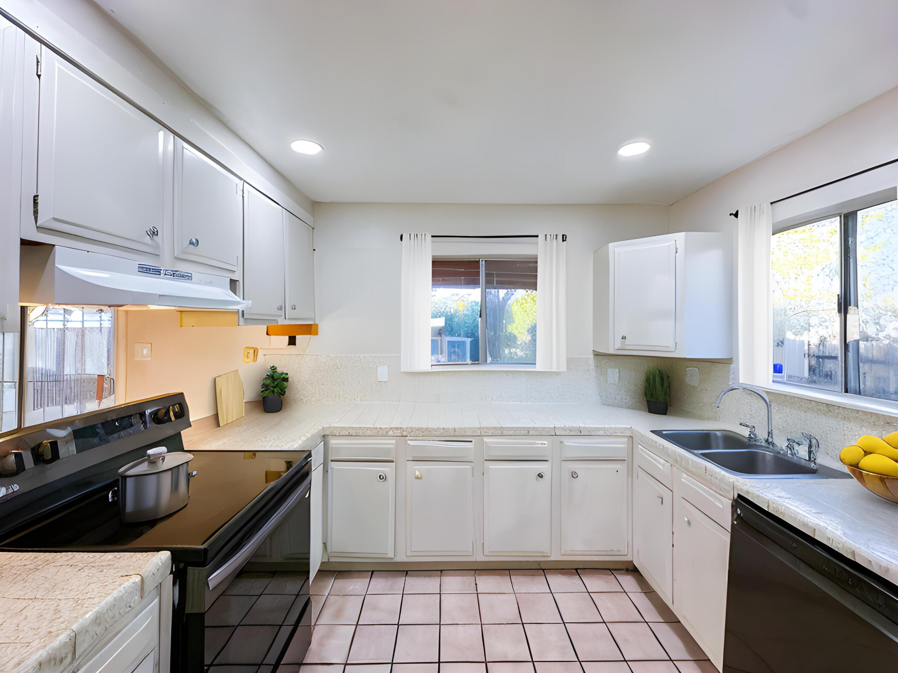 1228 West St George Avenue Ridgecrest, CA 93555 - Photo 10 of 30 a kitchen that has a sink and a stove in it