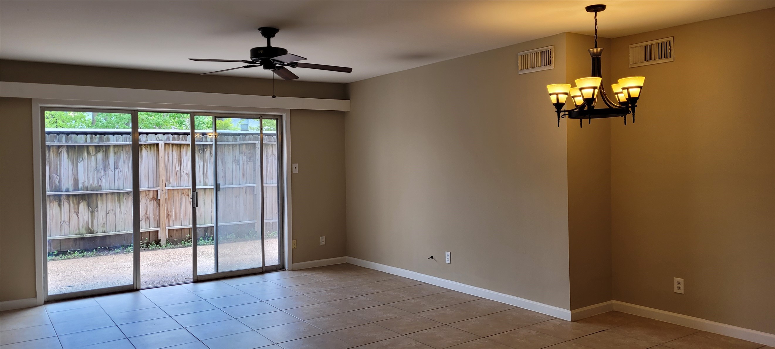 9031 Rue Cambon Street, Unit 69 Houston, TX 77074 - Photo 2 of 13 a view of a livingroom with a chandelier fan and windows