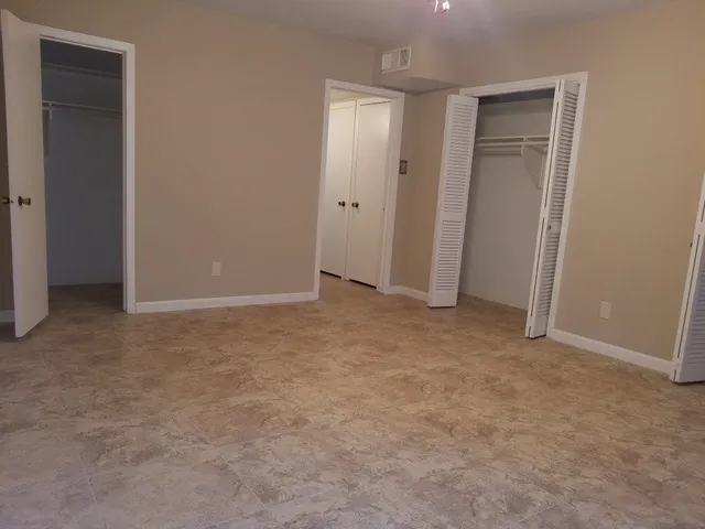 an empty room with closet area