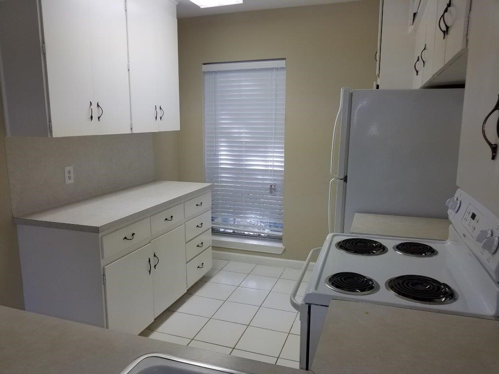 9031 Rue Cambon Street, Unit 69 Houston, TX 77074 - Photo 4 of 13 a kitchen with a refrigerator and a stove