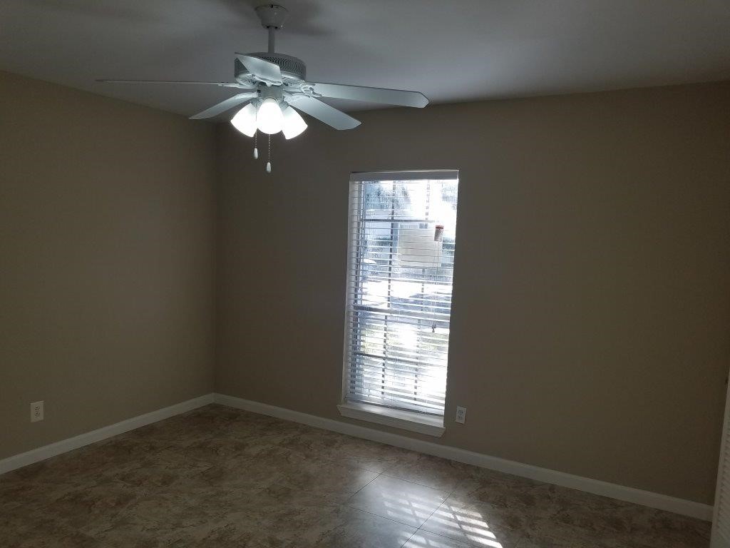 9031 Rue Cambon Street, Unit 69 Houston, TX 77074 - Photo 5 of 13 a view of a chandelier fan and window in an empty room