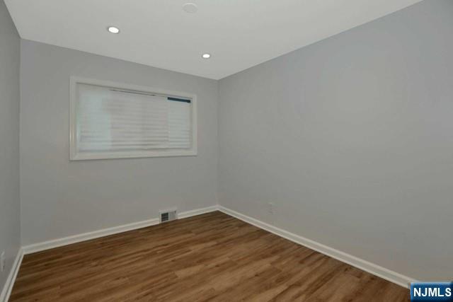 89 Wyoming Road Paramus, NJ 07652 - Photo 11 of 17 a view of empty room with wooden floor and fan