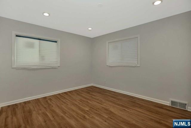 89 Wyoming Road Paramus, NJ 07652 - Photo 15 of 17 a room with wooden floor and windows