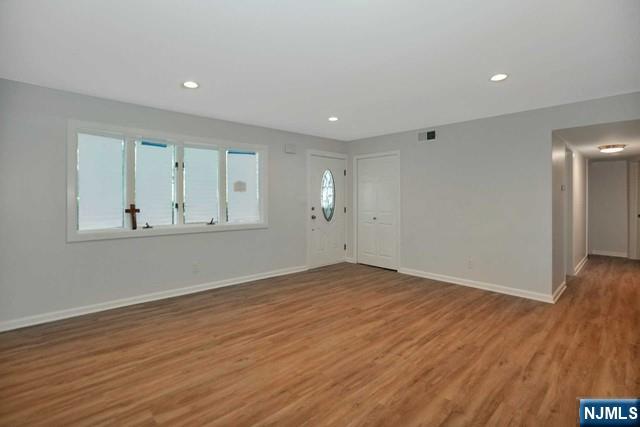 89 Wyoming Road Paramus, NJ 07652 - Photo 5 of 17 a view of empty room with wooden floor and fan