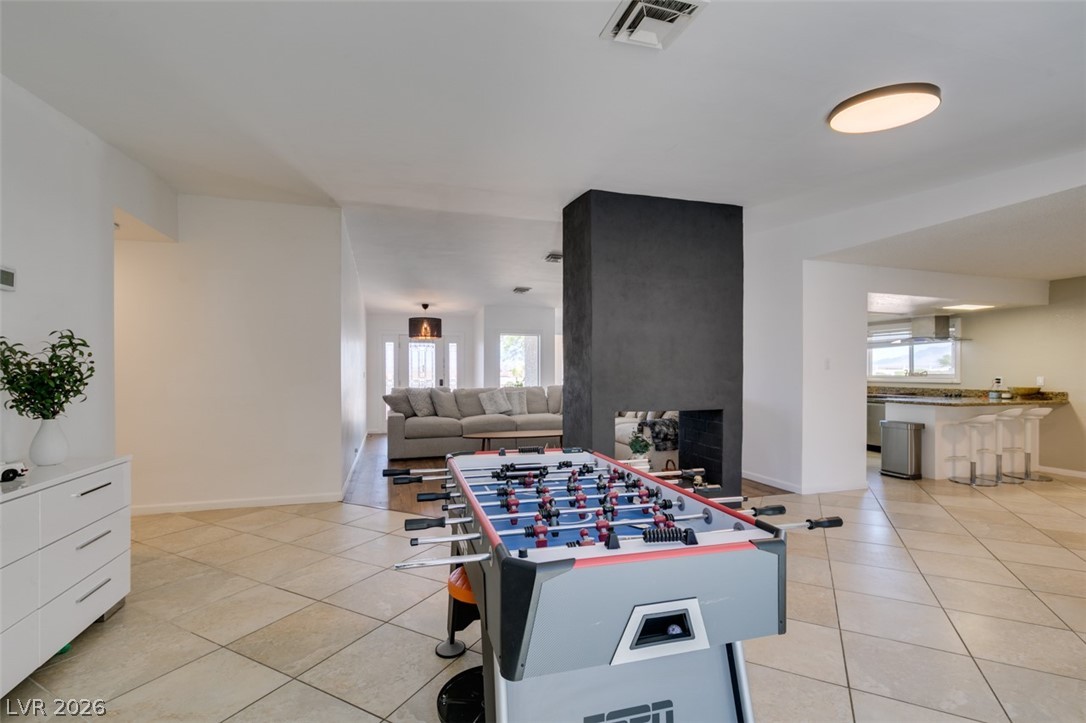 892 North Hollywood Boulevard Las Vegas, NV 89110 - Photo 29 of 81 Bright, expansive open-concept living space with a contemporary fireplace and a well-appointed kitchen.