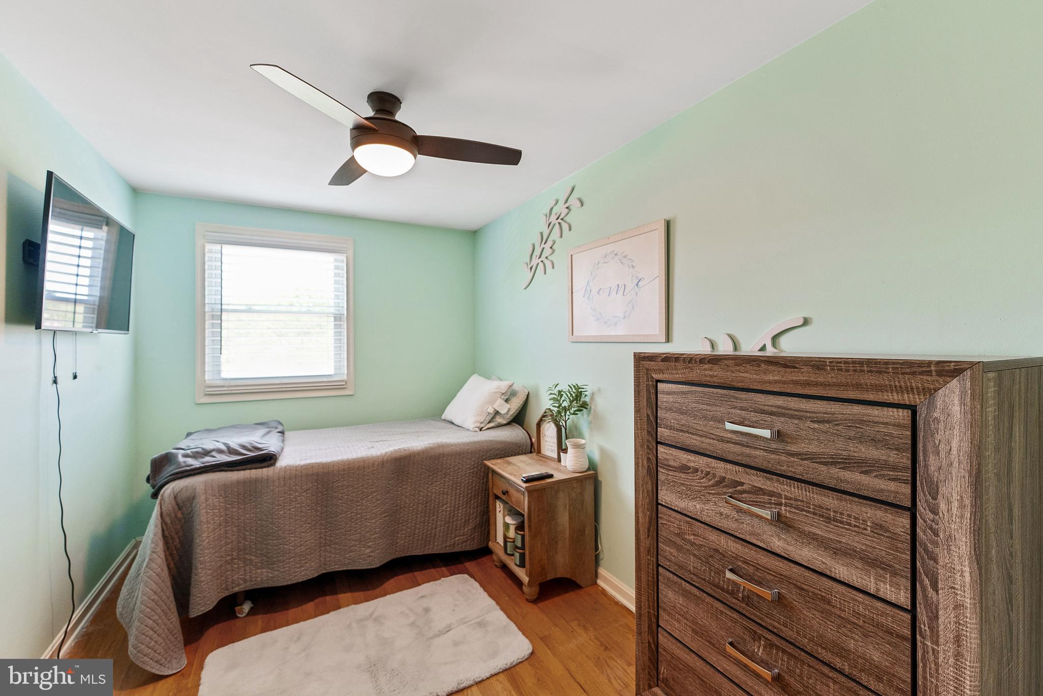 5633 Chelwynd Road Halethorpe, MD 21227 - Photo 27 of 41 a bedroom with a bed and wooden floor