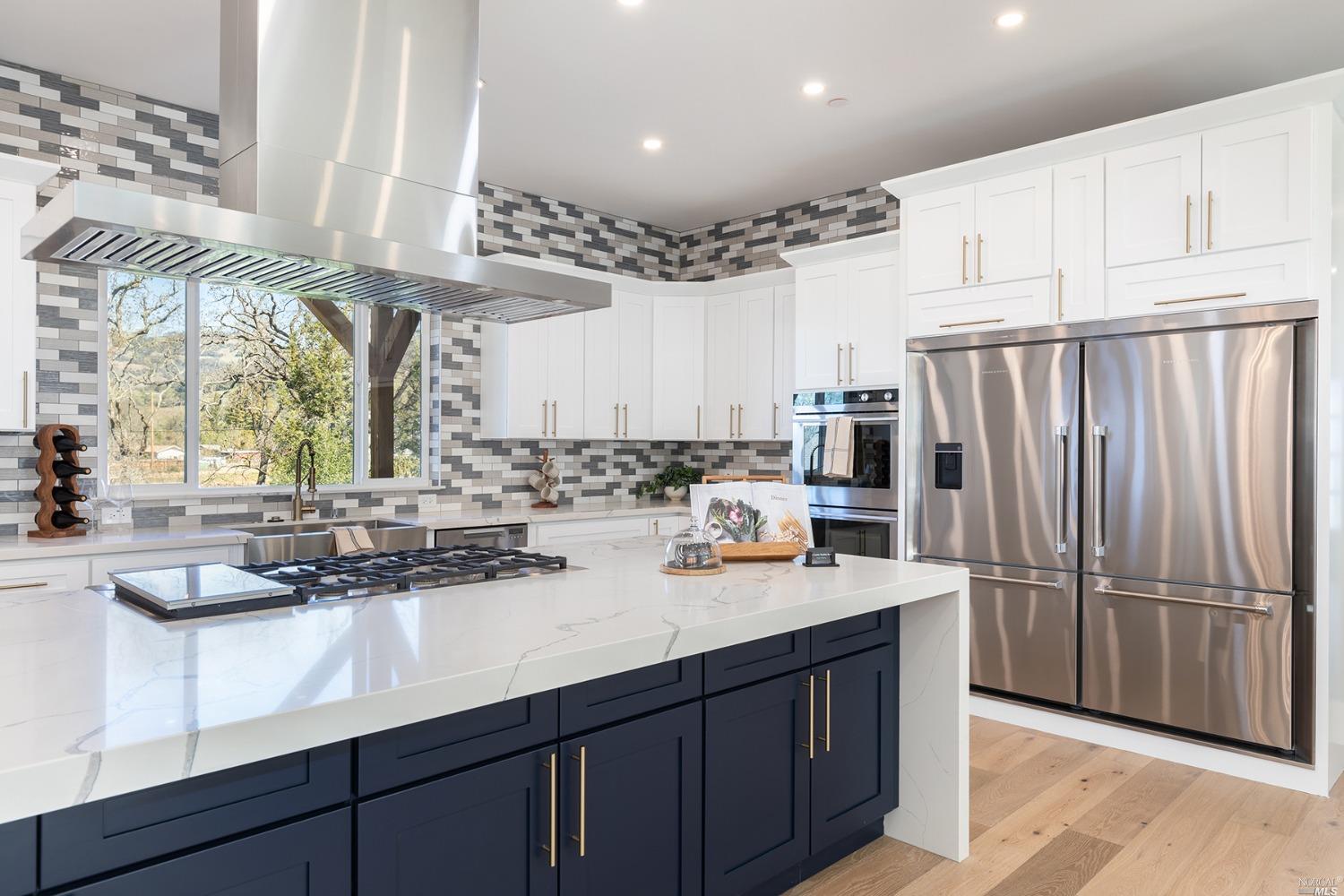 a kitchen with stainless steel appliances a sink and cabinets