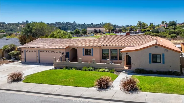 a front view of house with a garden and patio