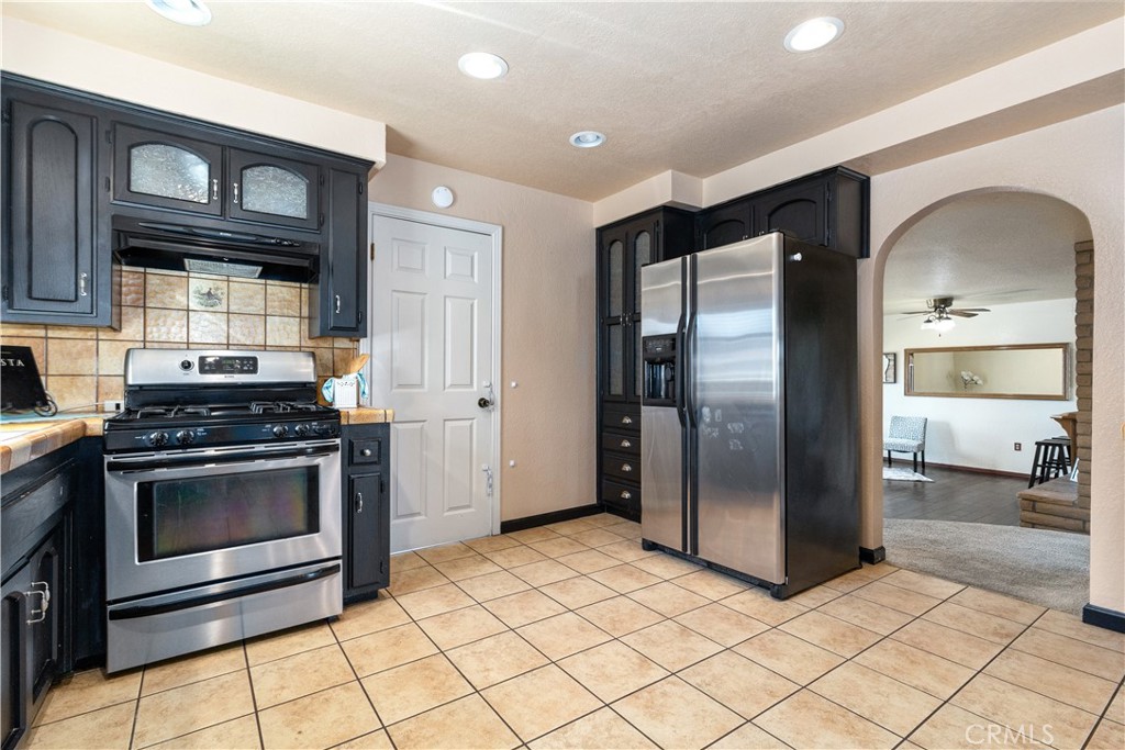 1024 Robin Circle Arroyo Grande, CA 93420 - Photo 16 of 35 a kitchen with stainless steel appliances granite countertop a stove a refrigerator and a cabinets