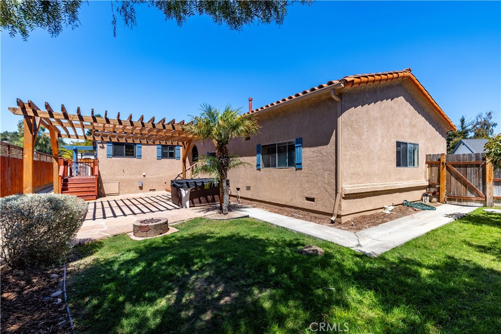 1024 Robin Circle Arroyo Grande, CA 93420 - Photo 28 of 35 a view of a white house with a big yard and potted plants