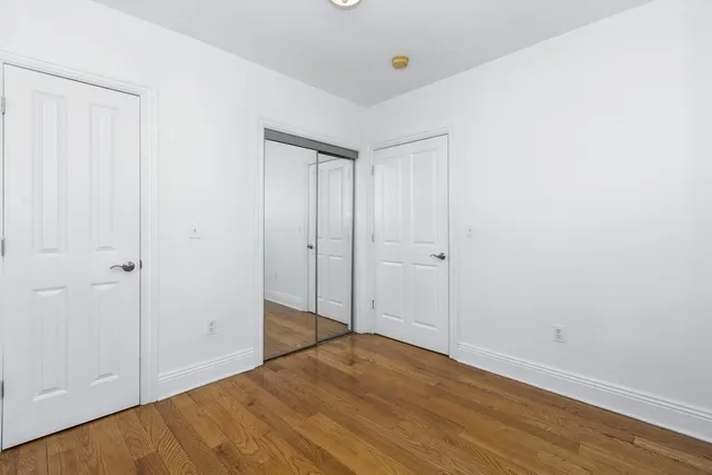 a view of hallway with wooden floor