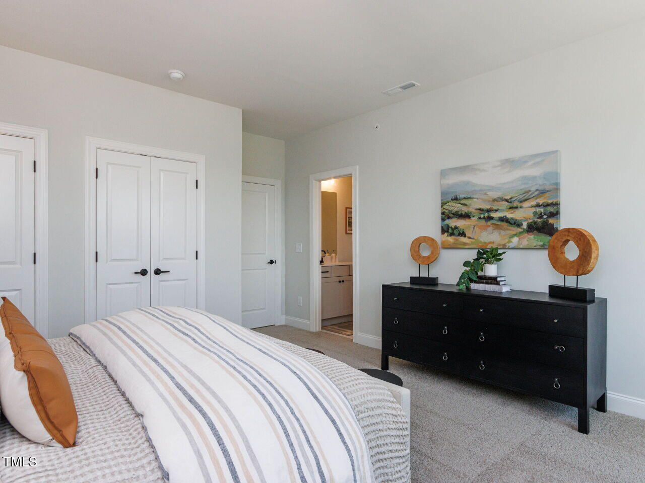 1031 Coldspring Circle Durham, NC 27705 - Photo 34 of 44 a bedroom with a bed and a mirror