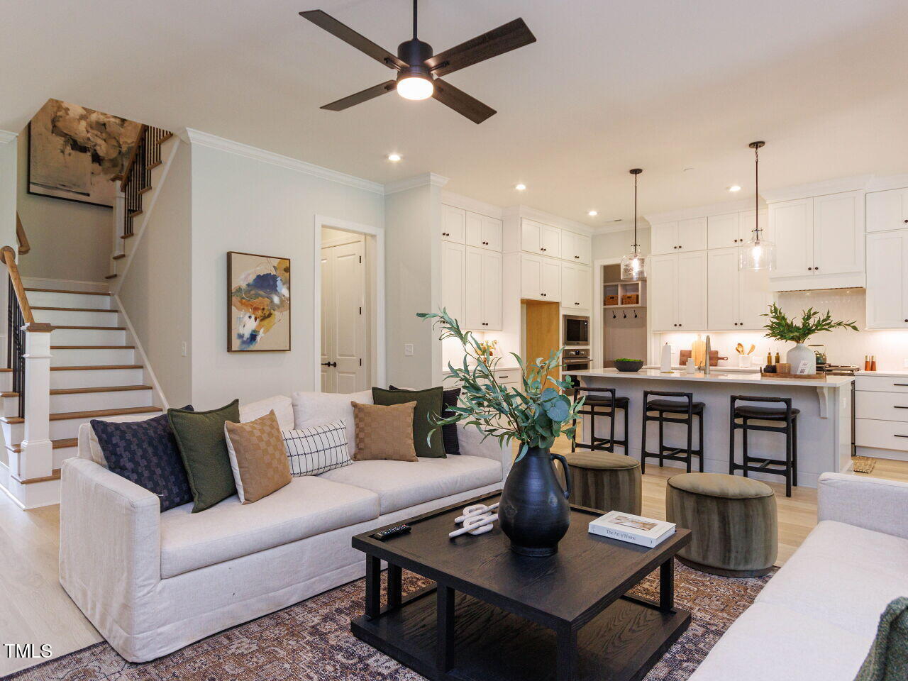 1031 Coldspring Circle Durham, NC 27705 - Photo 8 of 44 a living room with furniture kitchen view and a chandelier