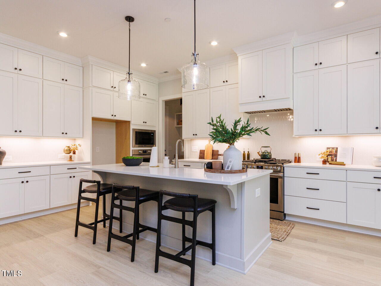 1031 Coldspring Circle Durham, NC 27705 - Photo 10 of 44 a kitchen with kitchen island a white table and chairs in it
