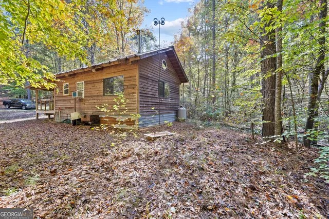 a view of a house with a yard and sitting area