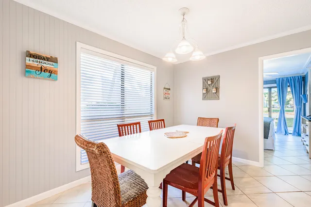 a view of a dining room with furniture and window