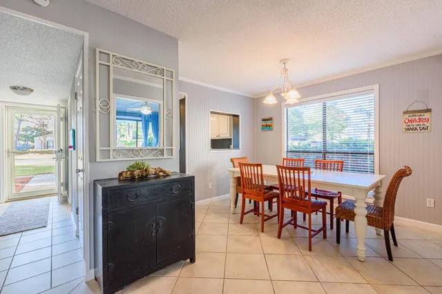 a view of a dining room with furniture and a window