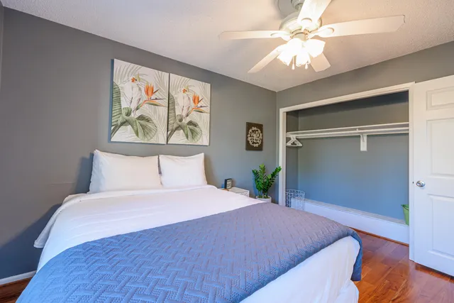 a bedroom with a large bed and a chandelier