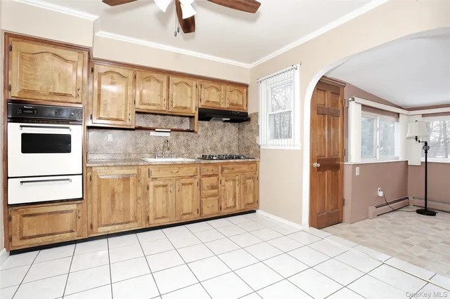 a kitchen with stainless steel appliances granite countertop a refrigerator and a stove