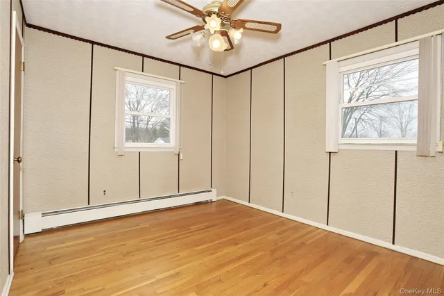 a view of a room with wooden floor and windows