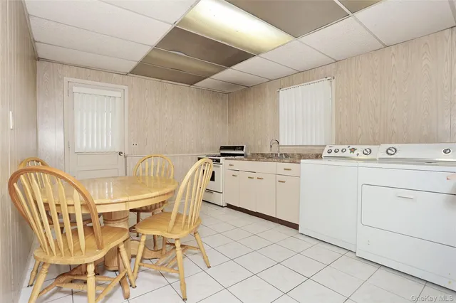 a utility room with cabinets washer and dryer