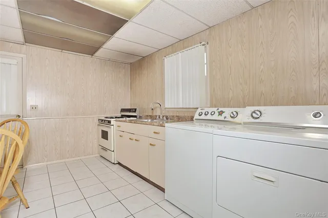 a white stove top oven sitting inside of a kitchen
