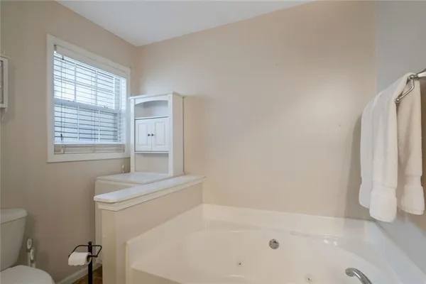 a bathroom with a bathtub and a window